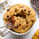 banana mug cake topped with chocolate chips close-up with a fork.