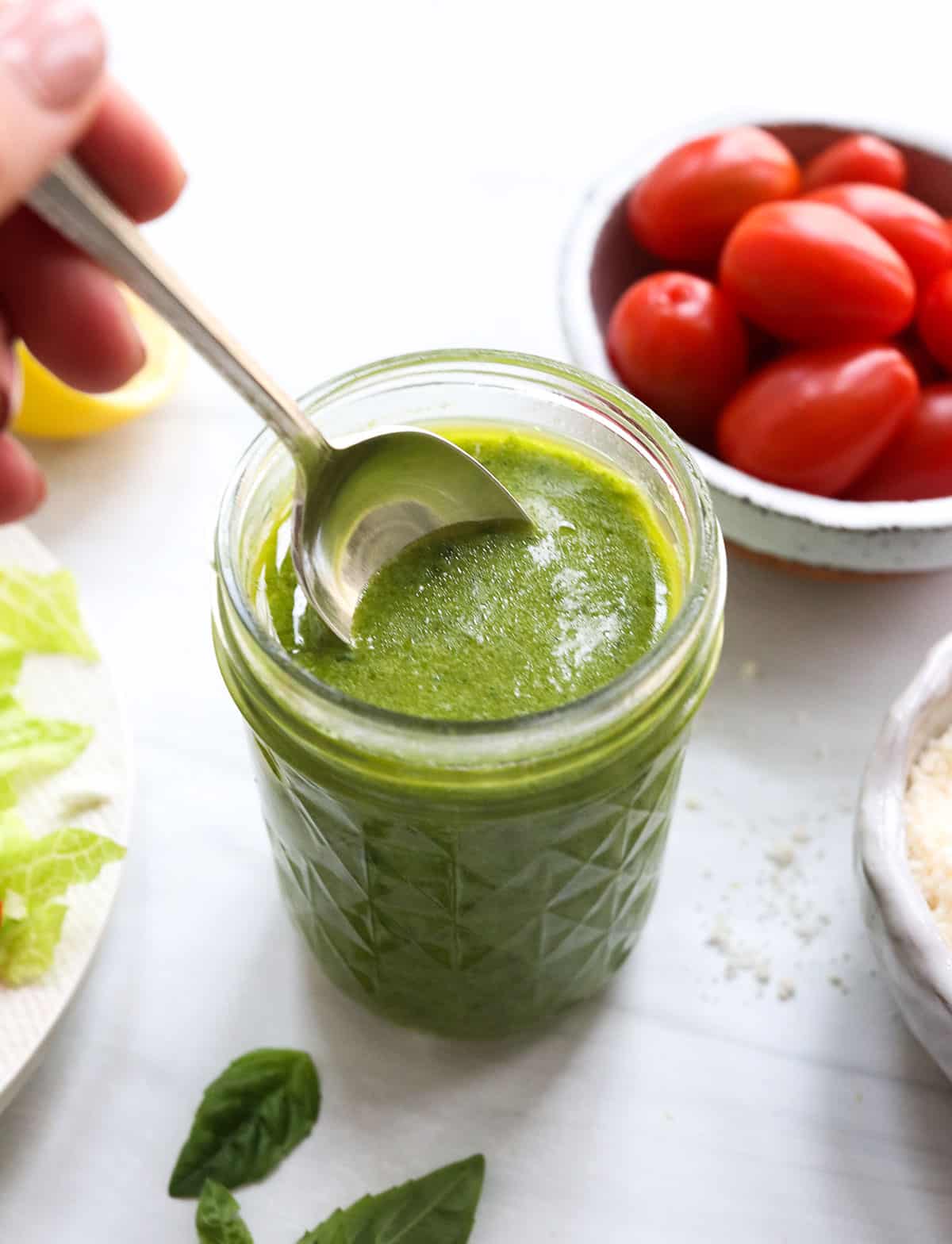 pesto salad dressing with spoon in the jar.