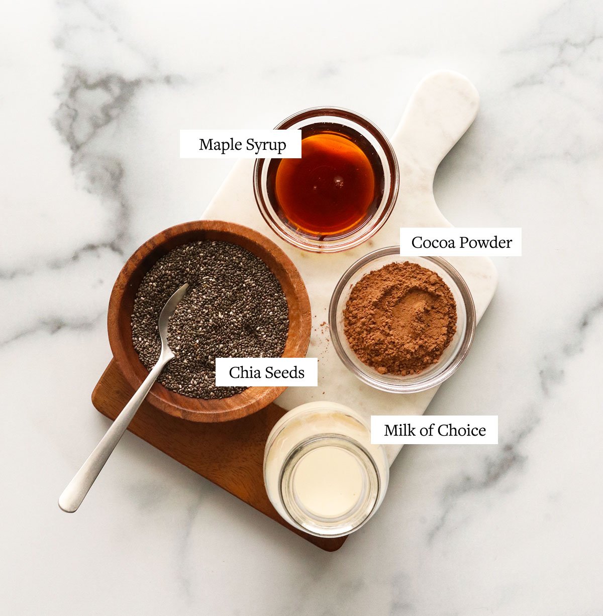 chocolate chia pudding ingredients labeled on a marble surface.