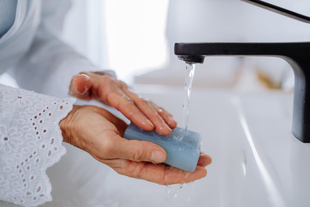 A close-up of woman washing hands with natural lavender soap, ecological sustainable lifestyle.