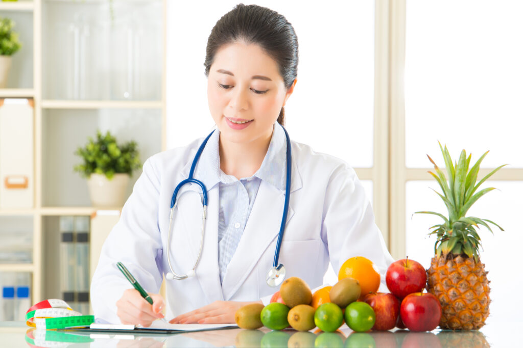 Nutritionist doctor writing meal plan