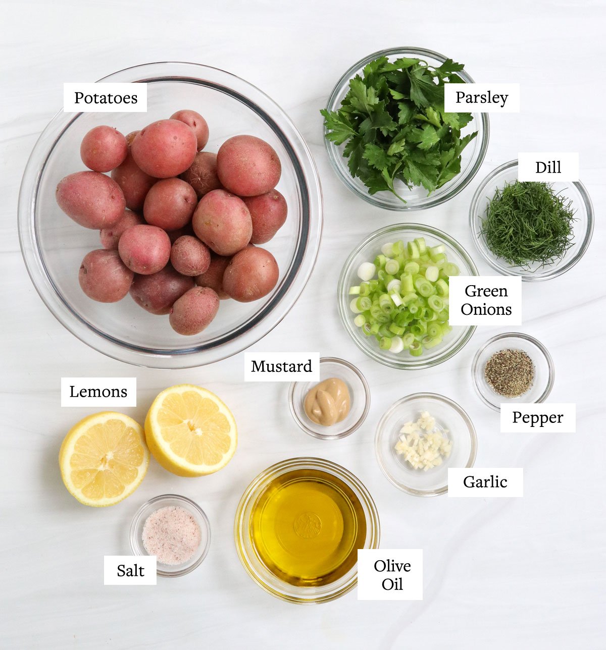 healthy potato salad ingredients in glass bowls.