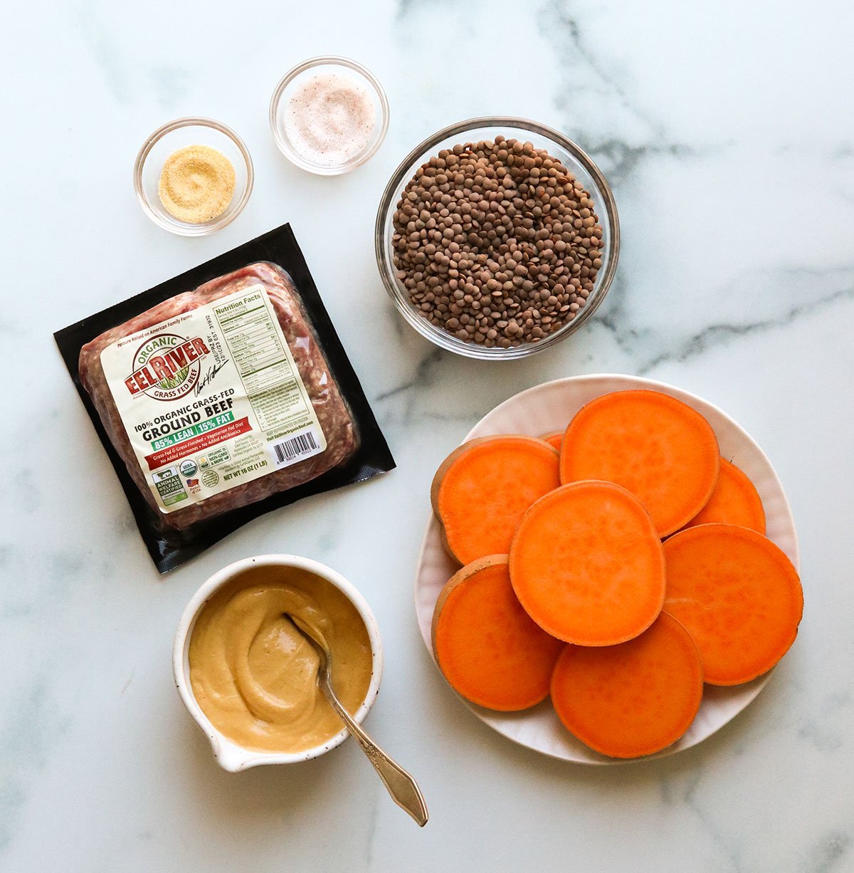 sweet potato slider ingredients on a marble surface.