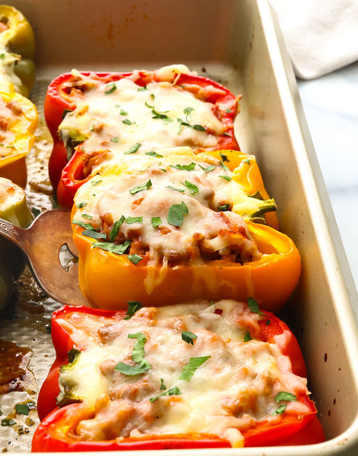 turkey stuffed bell peppers in a baking sheet.