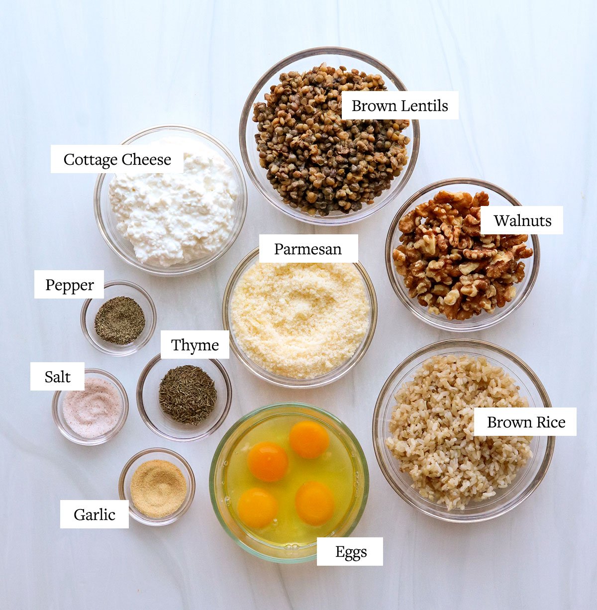 vegetarian meatloaf ingredients labeled in glass bowls.